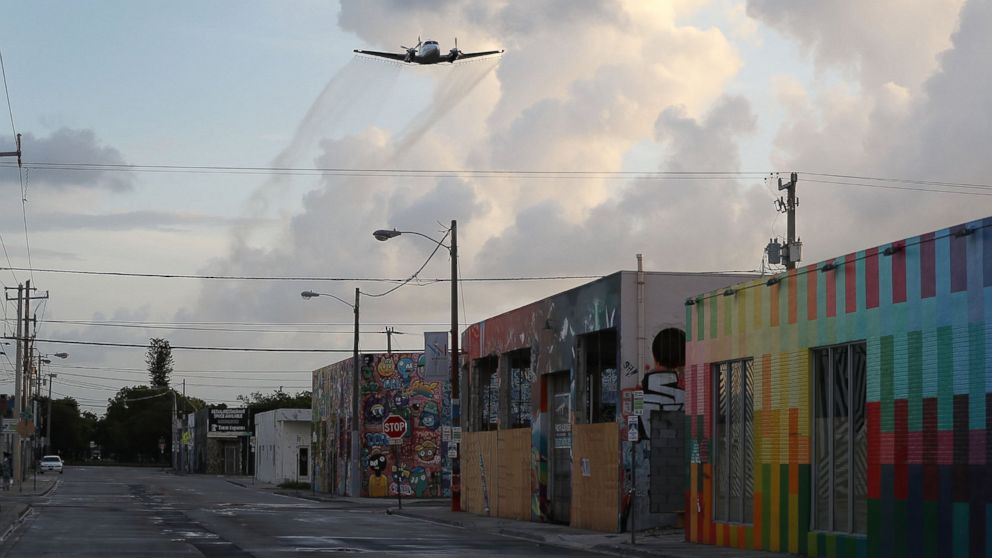 A plane sprays pesticide over the Wynwood neighborhood of Miami, FL in the hope of controlling and reducing the number of mosquitos, some of which may be capable of spreading the Zika virus on August 6, 2016.