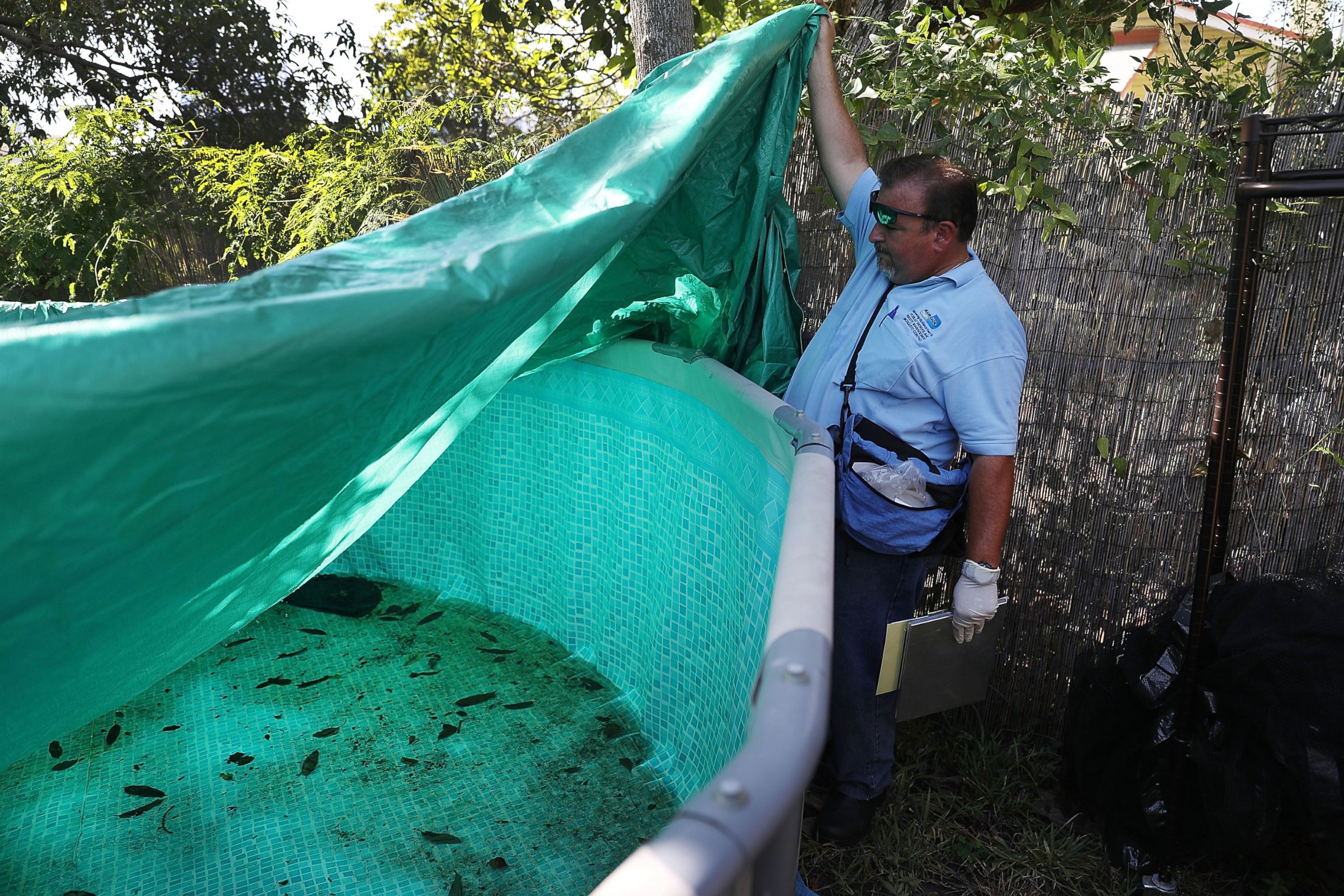 PHOTO: Robert Muxo, a Miami-Dade County mosquito control inspector, inspects a property for mosquitos or breeding areas in the Wynwood neighborhood as the county fights to control the Zika virus outbreak on July 30, 2016 in Miami. 