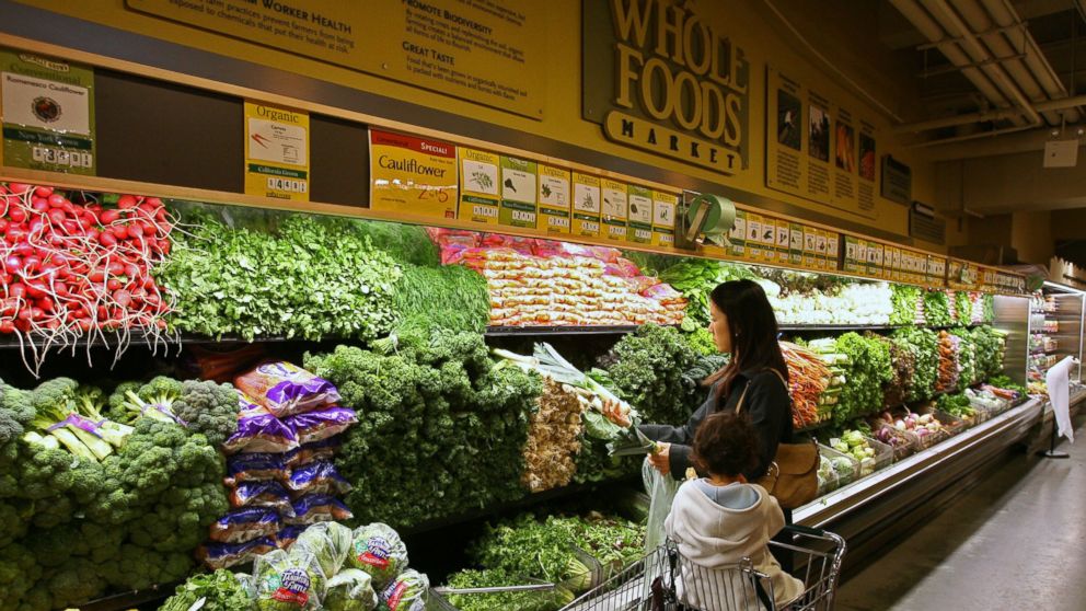 Sachiko Shioya and her daughter Momo, 3, shop for produce at a Whole Foods Market, in New York City.