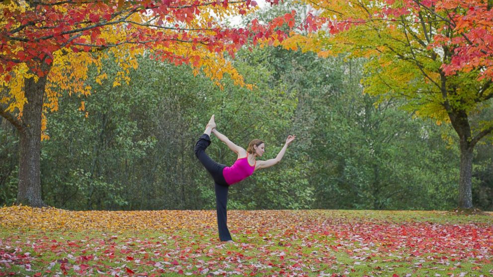 A woman practises yoga in the forest in this undated file photo.