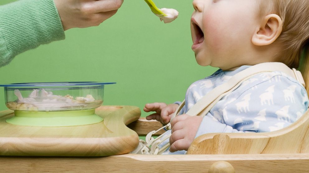 A baby is seen being fed in a highchair in this undated file photo. 
