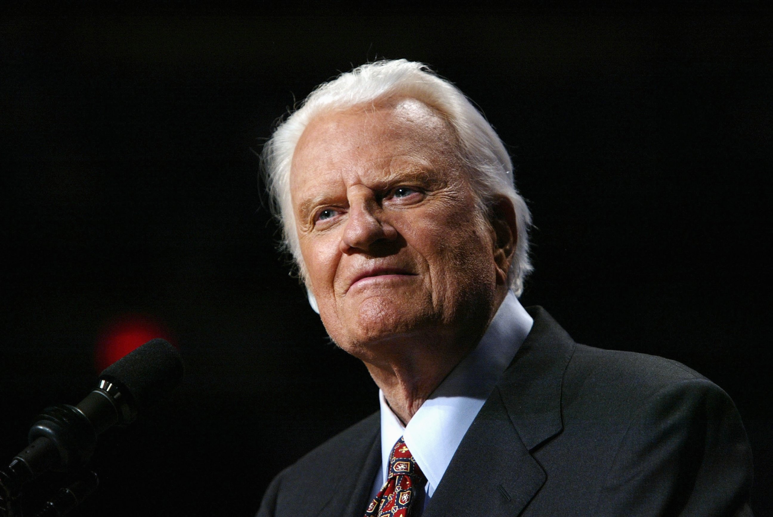 PHOTO: Evangelist Billy Graham looks on from the podium at a Billy Graham rally on June 13, 2003 in Oklahoma City, Okla.