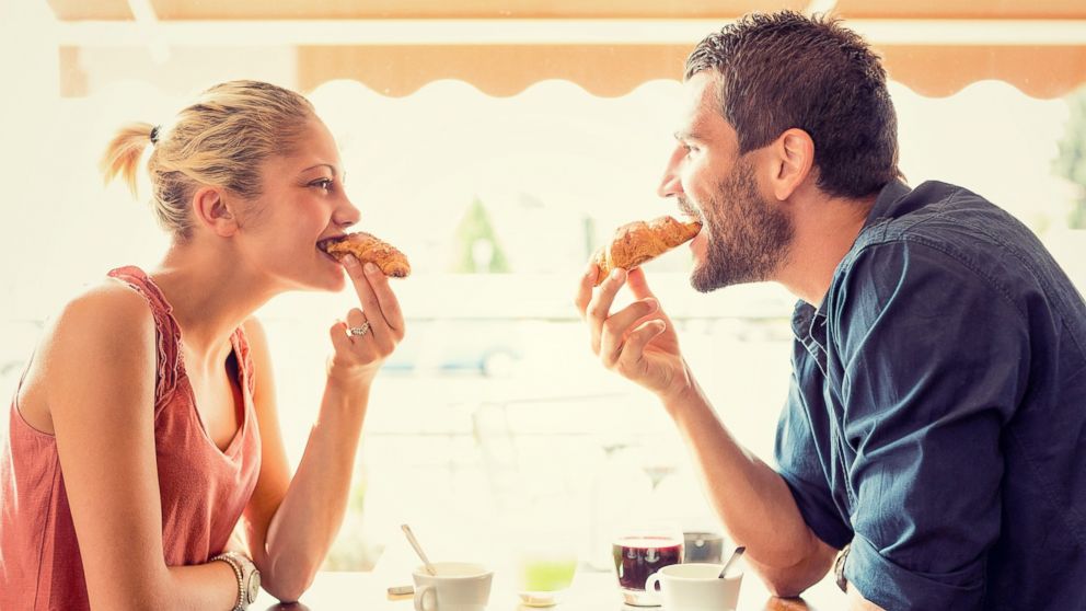 In this stock image, a couple is pictured eating croissants. 