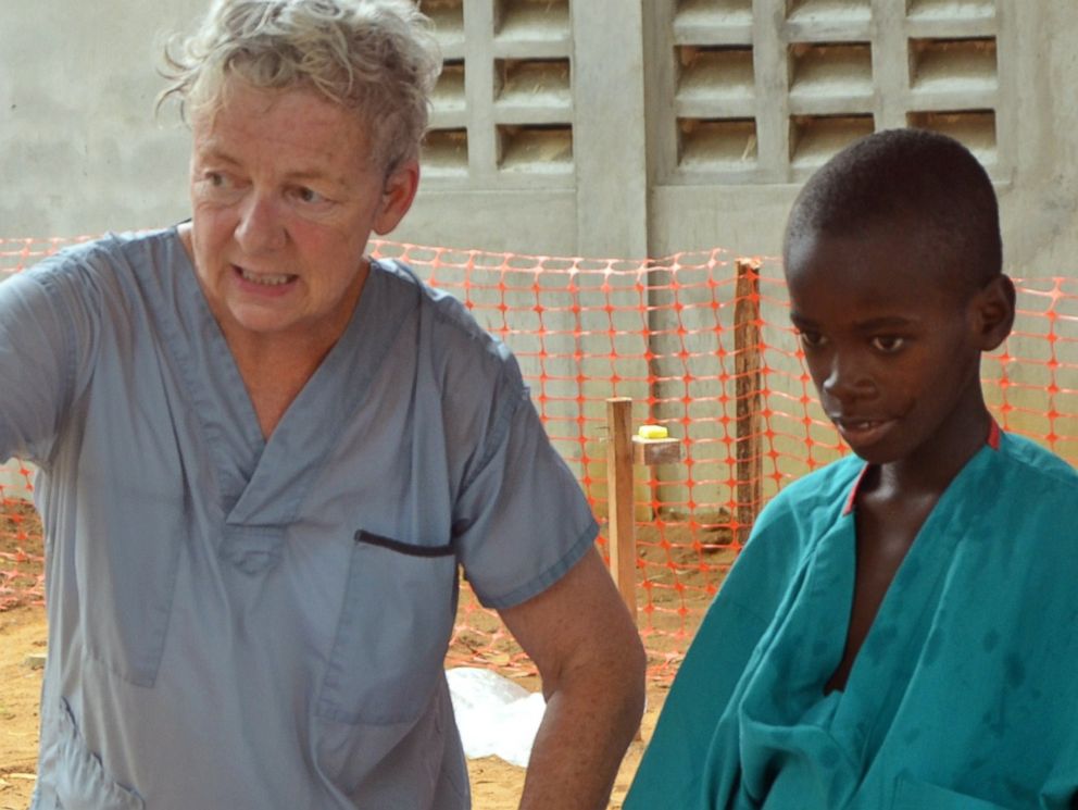 PHOTO: A 10-year-old boy walks with a doctor from Christian charity Samaritans Purse, after being taken out of quarantine and receiving treatment following his mothers death caused by the ebola virus.