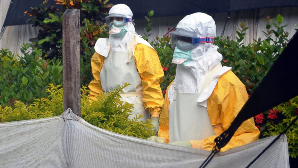 Members of Doctors Without Borders are pictured wearing protective gear outside an isolation ward of the Donka Hospital on July 23, 2014 in Conakry, Guinea.