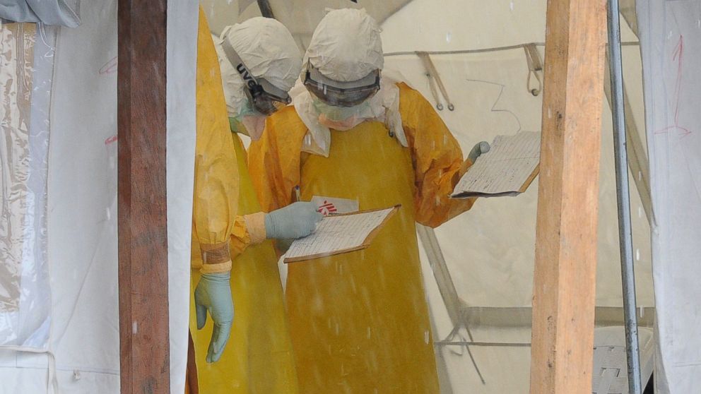 Health care workers wearing protective suits work at the ELWA Hospital Aug. 30, 2014, in Monrovia, Liberia.