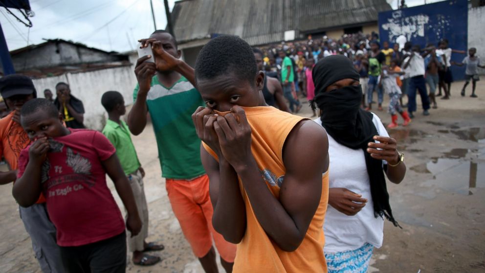 A mob overruns an Ebola isolation center in the West Point slum on August 16, 2014 in Monrovia, Liberia. 