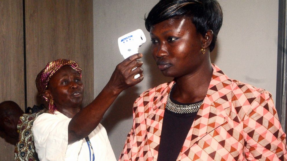 Employees of the sanitary control of Conakry airport check passengers before they leave the country, April 10, 2014, in Guinea.