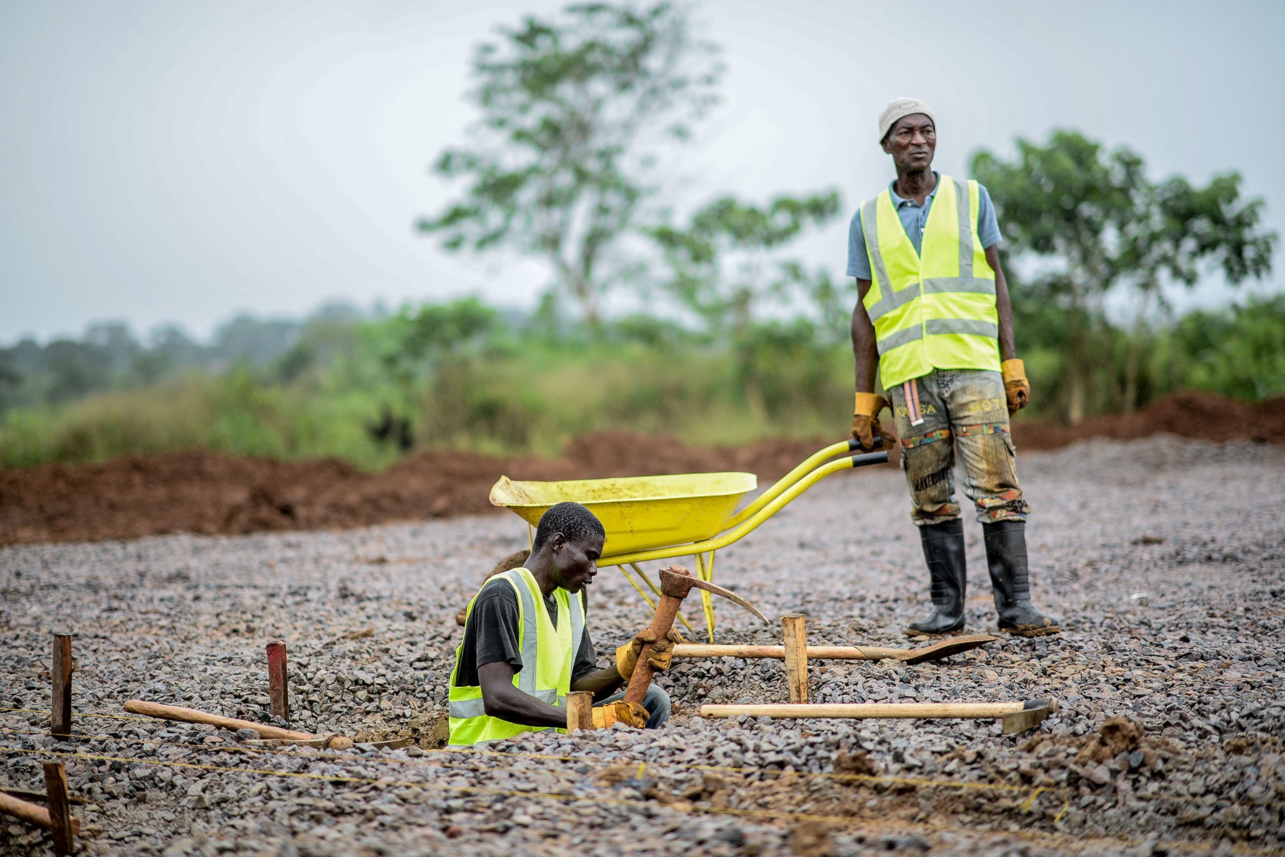 PHOTO: A worker from the International Committee of the Red Cross digs a hole with a pickaxe during the construction a brand new health center in Kenema, Sierra Leone on Aug. 25, 2014. 