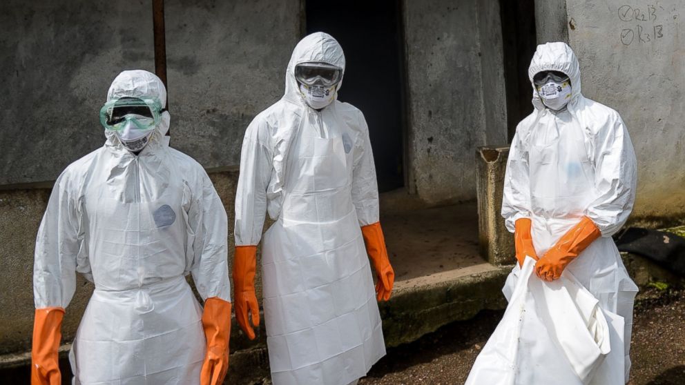 PHOTO: A group of young volunteers wear special uniforms and sterilize around a house after Baindu Koruma, 28, died due to the Ebola virus in Lango village, Kenema, Sierra Leone on Aug. 25, 2014. 