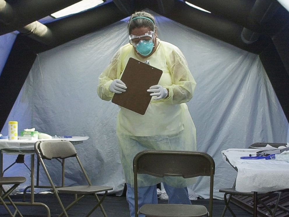 PHOTO: Deddie Craig, a registered nurse at UNC Hospitals, retrieves paperwork from a screening tent at the SARS medical screening facility on June 13, 2003 in Chapel Hill, N.C.