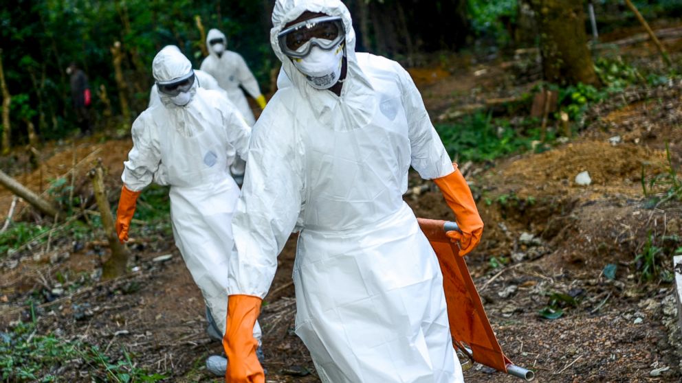 Members of a volunteer medical team wear special uniforms for the burial of people, sterilized after dying due to the Ebola virus, in Kenema, Sierra Leone, Aug. 26, 2014. 