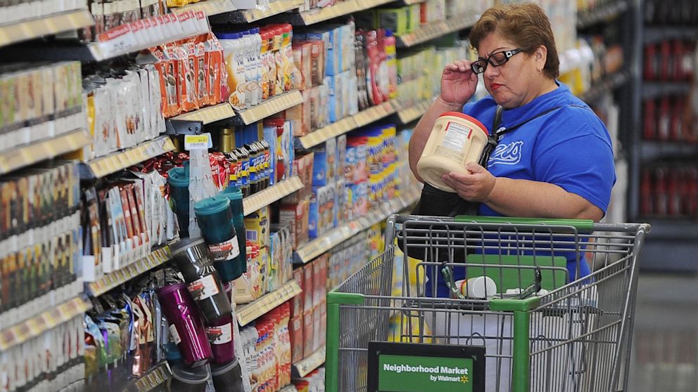 A shopper reads the label on a package of non-dairy creamer at the Walmart Neighborhood Market in Panorama City, California, Sept. 28, 2012. 