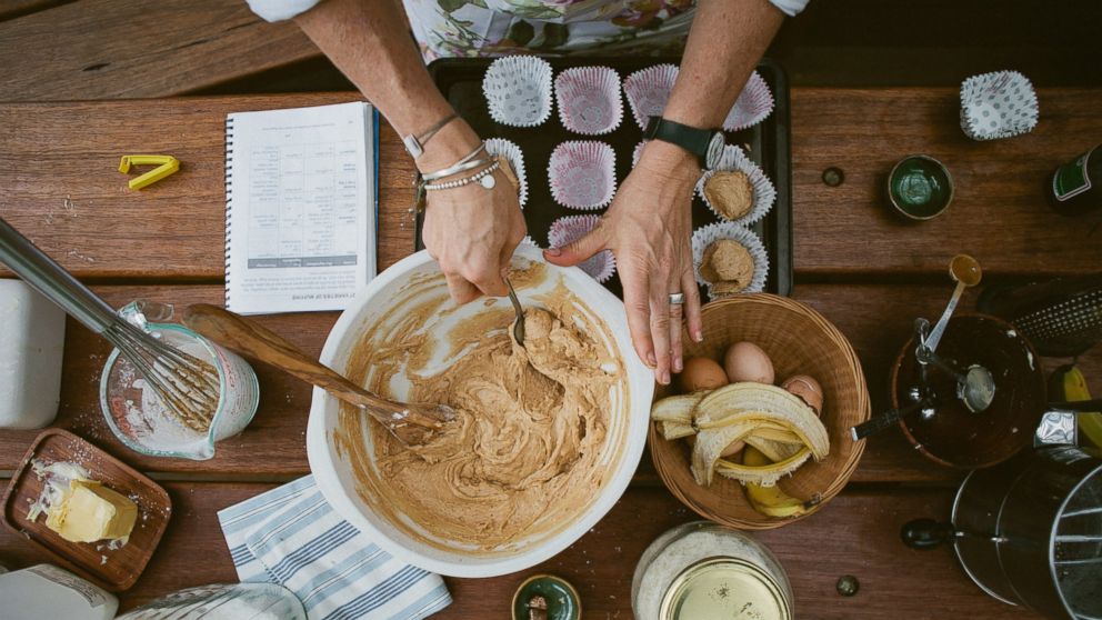 PHOTO: A baker mixes ingredients for gluten-free banana muffins.