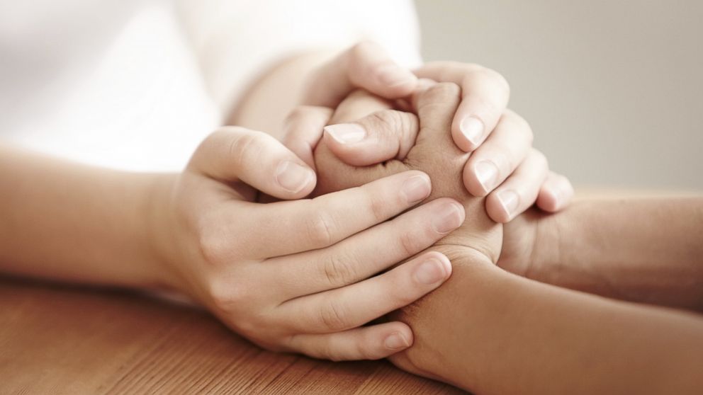 Two people hold hands in this undated file photo.