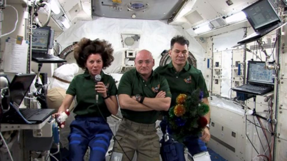 Flight Engineer Catherine Coleman, Commander Scott Kelly, and Flight Engineer Paolo Nespoli, memebers of the Expedition 26 crew, send their holiday greetings to Earth from the International Space Station, on Dec. 25, 2010 in space.