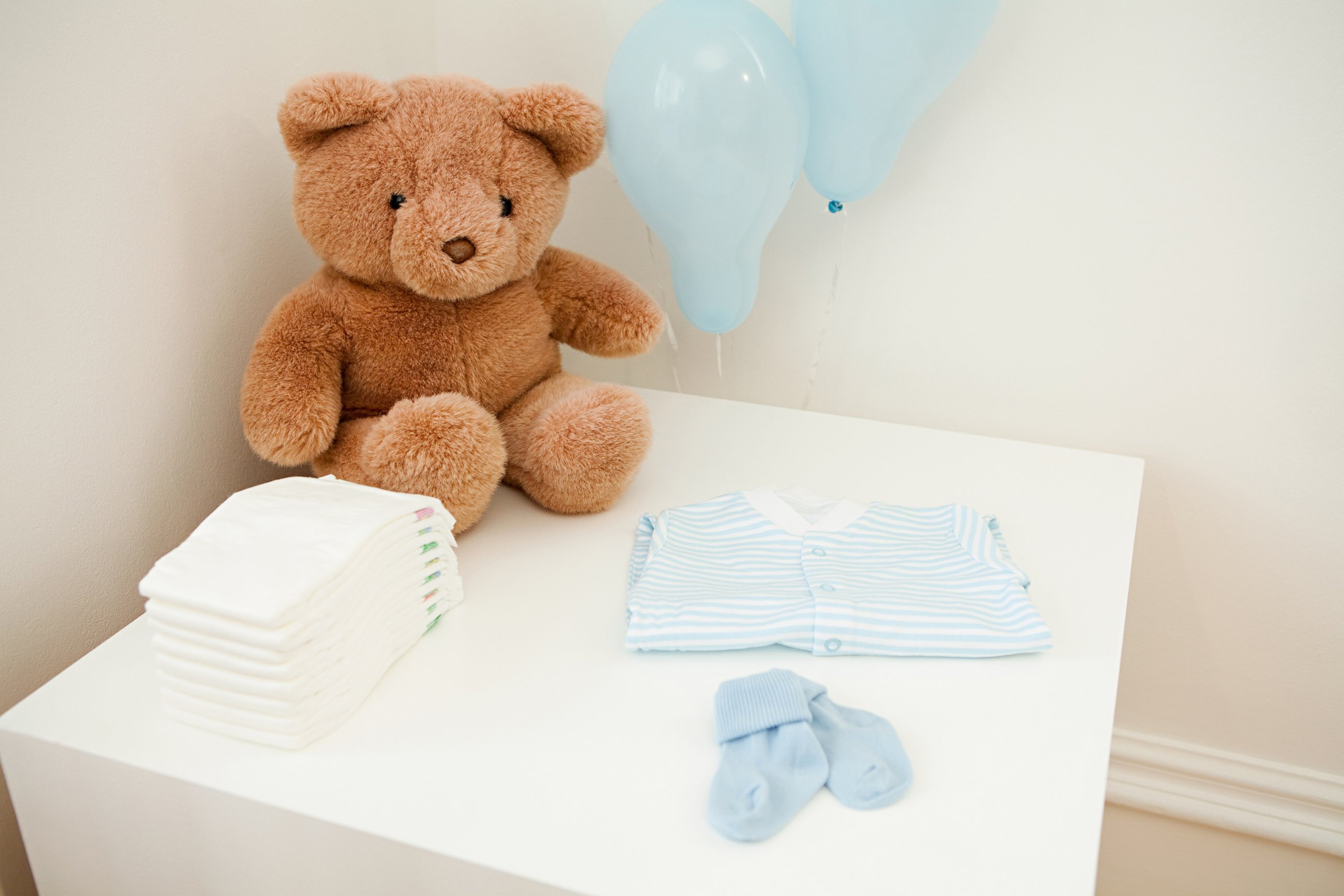 PHOTO: Baby clothes and teddy bear are set out for newborn baby in this undated stock photo.