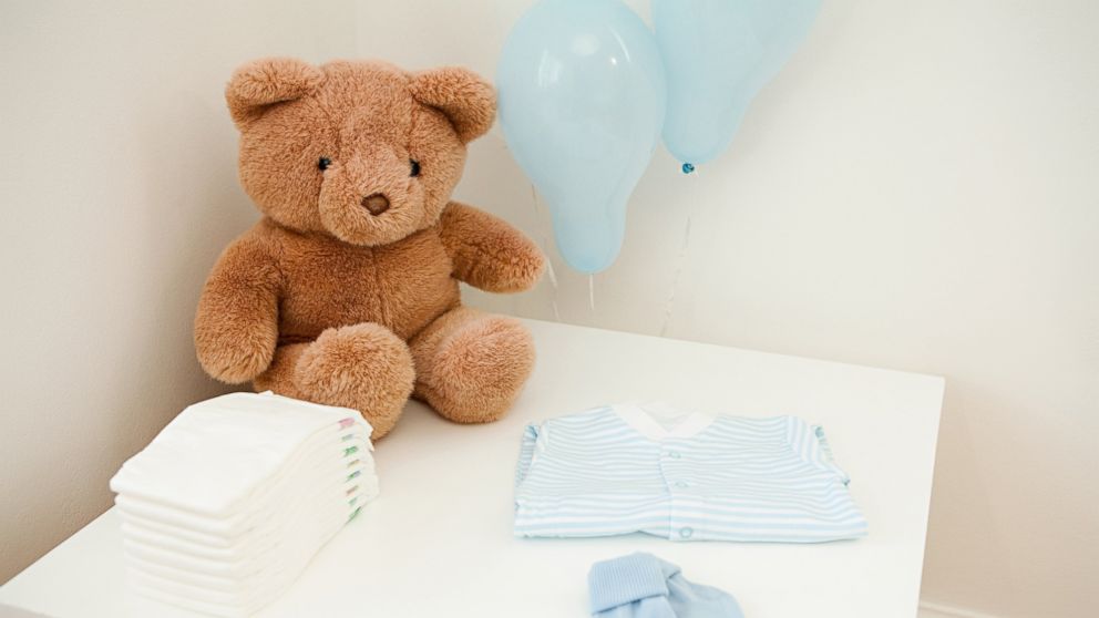 PHOTO: Baby clothes and teddy bear are set out for newborn baby in this undated stock photo.