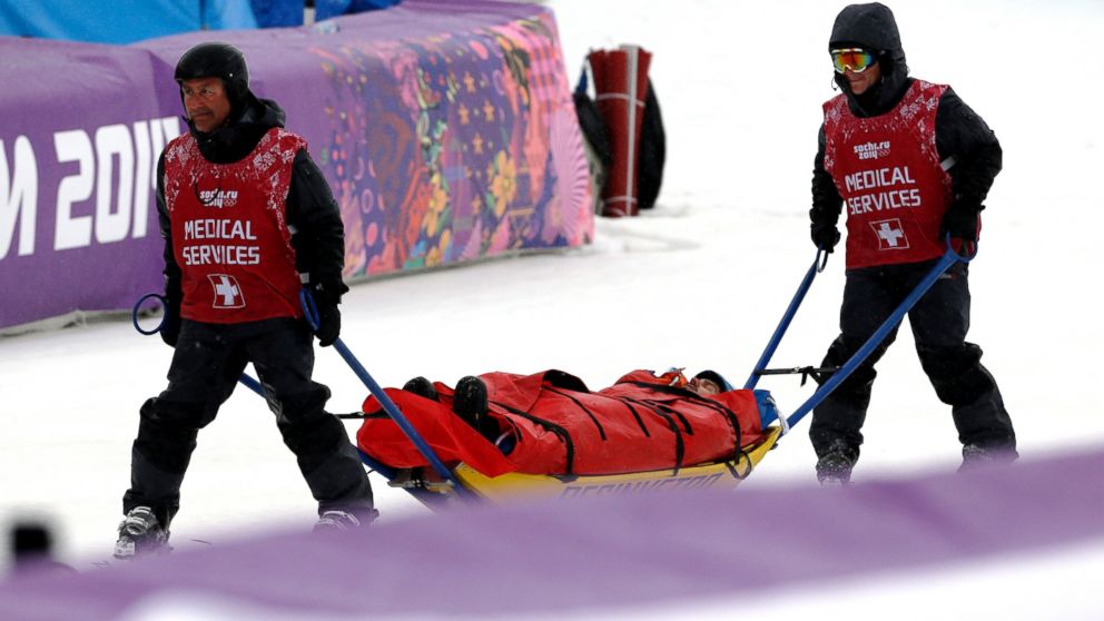 Italy's Omar Visintin is carried off the course in a stretcher after crashing in the second semifinal of the men's snowboard cross at the Rosa Khutor Extreme Park, at the 2014 Winter Olympics, Feb. 18, 2014, in Krasnaya Polyana, Russia.