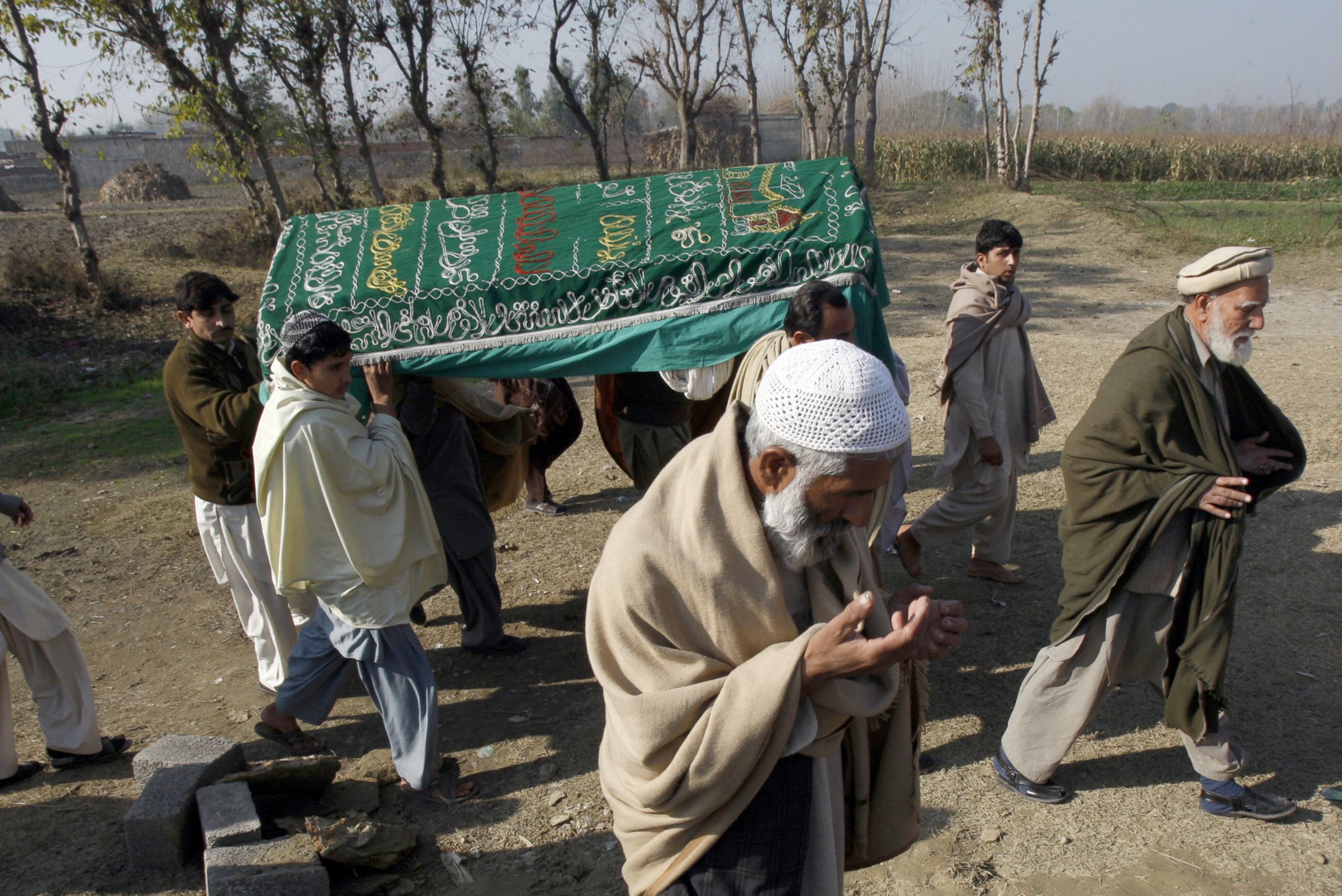 PHOTO: Mourners carry a coffin of a Pakistani charity worker, who was killed with other colleagues during yesterday's attack by gunmen, in Swabi, January 2, 2013.