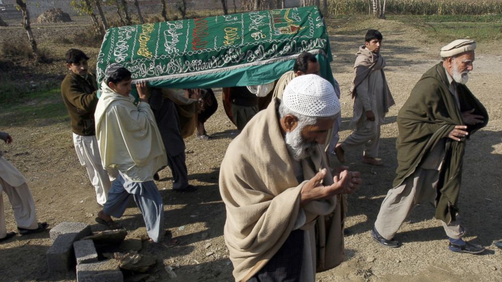 PHOTO: Mourners carry a coffin of a Pakistani charity worker, who was killed with other colleagues during yesterday's attack by gunmen, in Swabi, January 2, 2013.