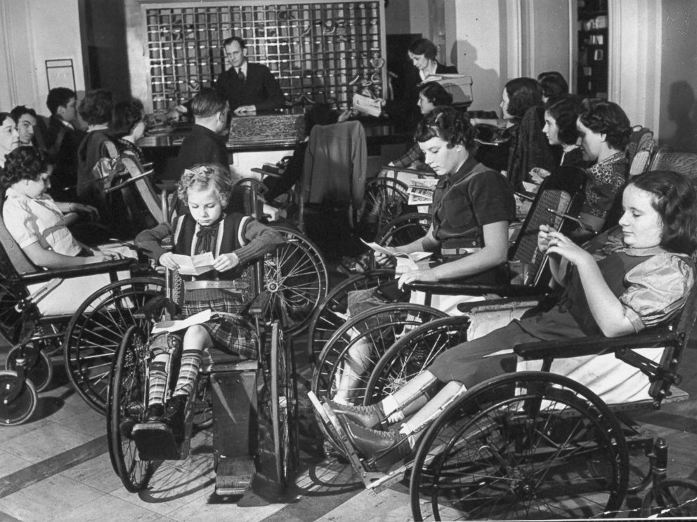 PHOTO: Young polio patients read letters from home while gathered around mailroom desk during mail call at FDR's Georgia Warm Springs Foundation while receiving intensive treatment.