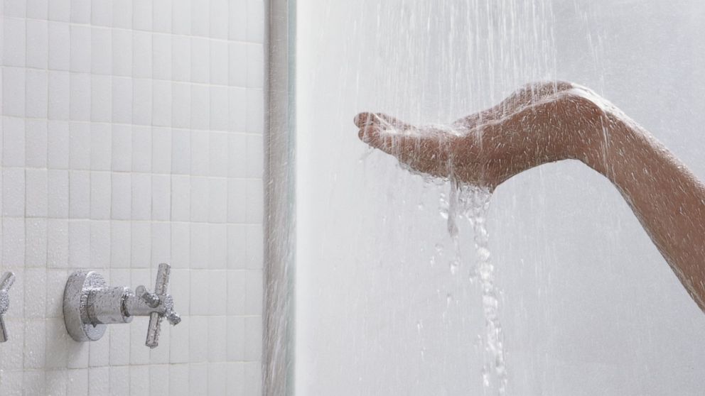 A person tests a shower in this undated file photo.
