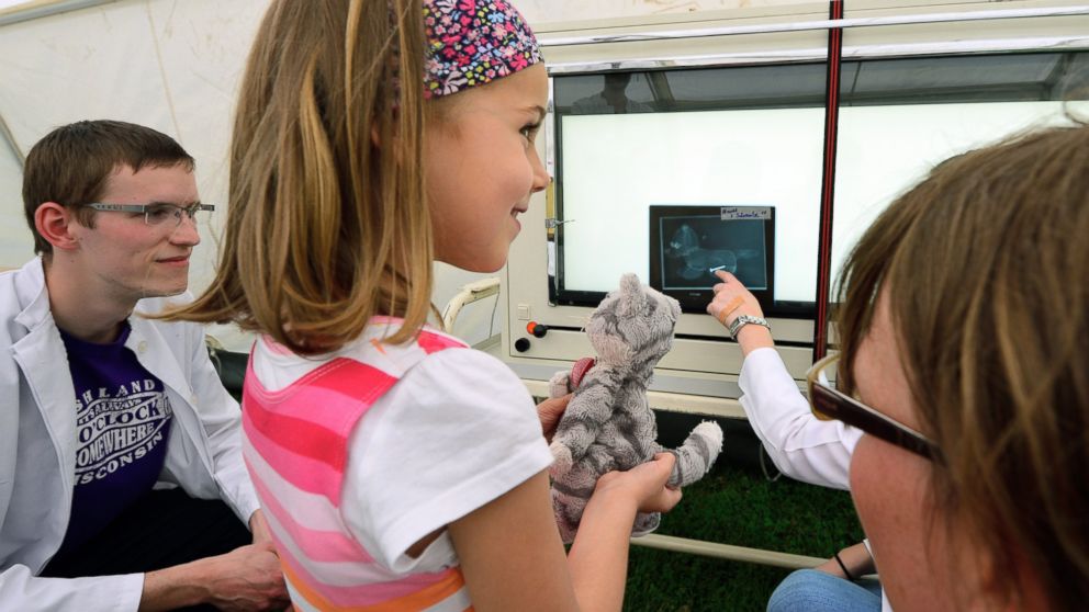 PHOTO: Paula, age 5, and her stuffed cat Trudi, attend a "consultation" with doctors in the X-ray tent of the "Teddy Clinic'' on June 4, 2014 in Giessen, Germany. 