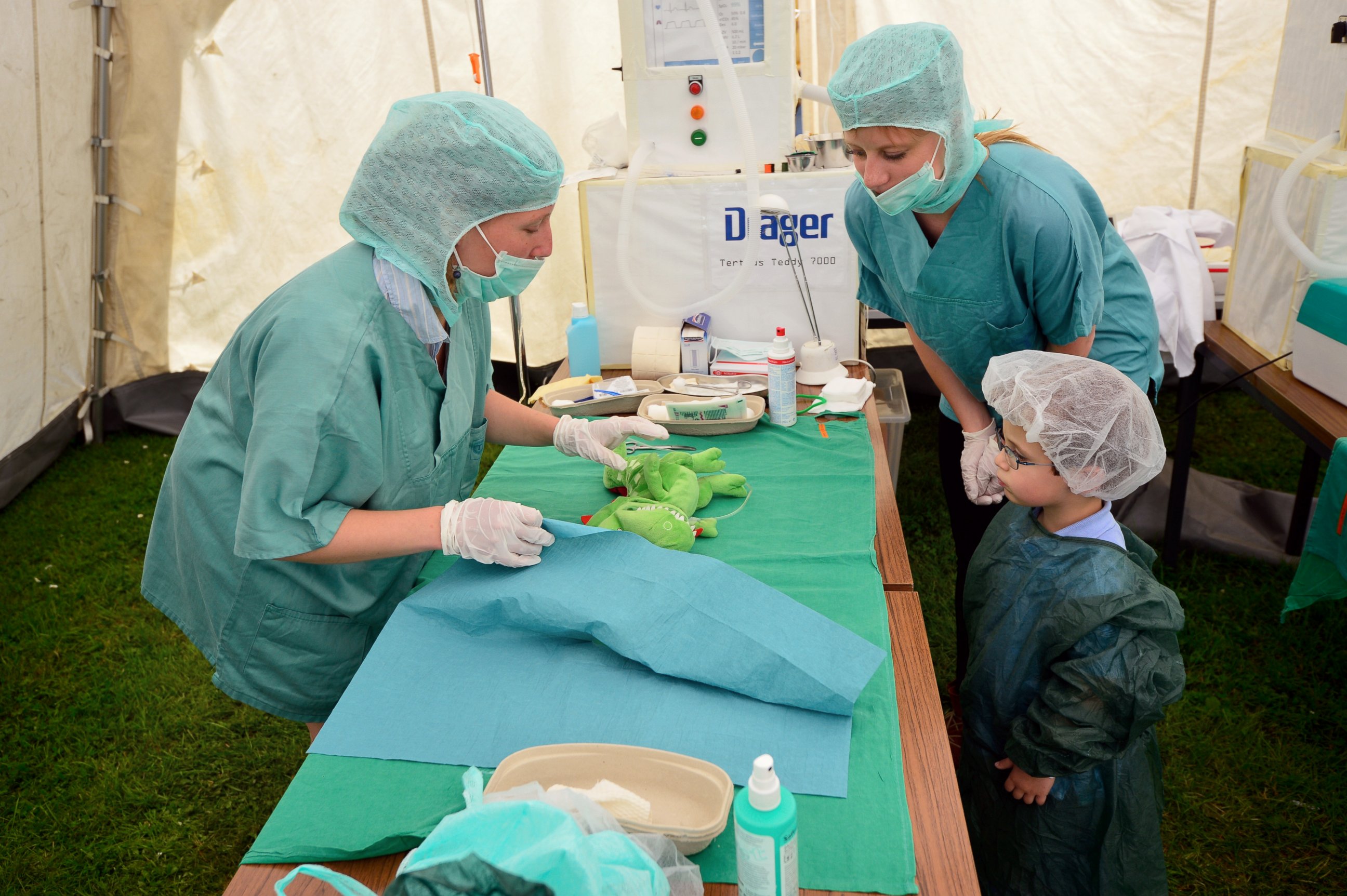 PHOTO: Tristan, age 3, attends the "operation" of his stuffed dragon in the operating room of the "Teddy Clinic'' on June 4, 2014 in Giessen, Germany.