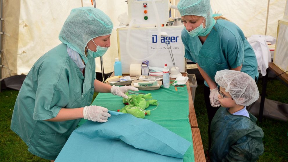 PHOTO: Tristan, age 3, attends the "operation" of his stuffed dragon in the operating room of the "Teddy Clinic'' on June 4, 2014 in Giessen, Germany.