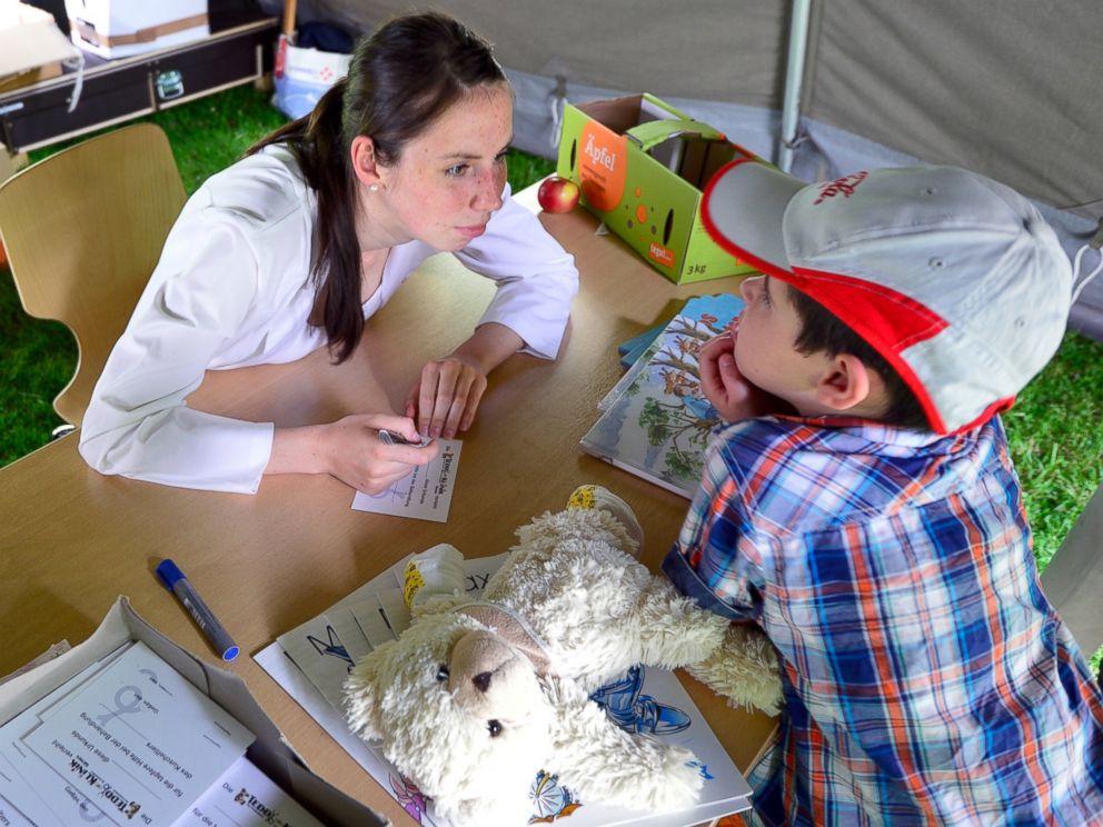 PHOTO: A child gets medicine for his teddy bear at the Teddy Clinic on June 4, 2014 in Giessen, Germany.