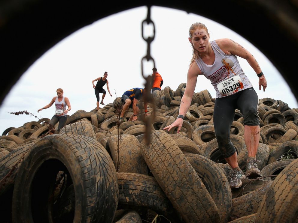 PHOTO: Competitors run over a tire pit during Toughmudder at Phillip Island Grand Prix Circuit, March 23, 2014 in Phillip Island, Australia.
