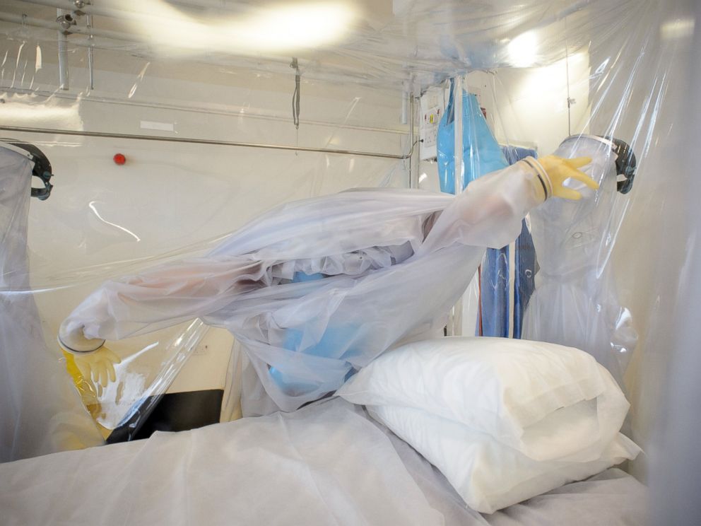 PHOTO: A nurse wears protective clothing as he demonstrates the facilities in place at the Royal Free Hospital in north London, Aug. 6, 2014, in preparation for a patient testing positive for the Ebola virus.