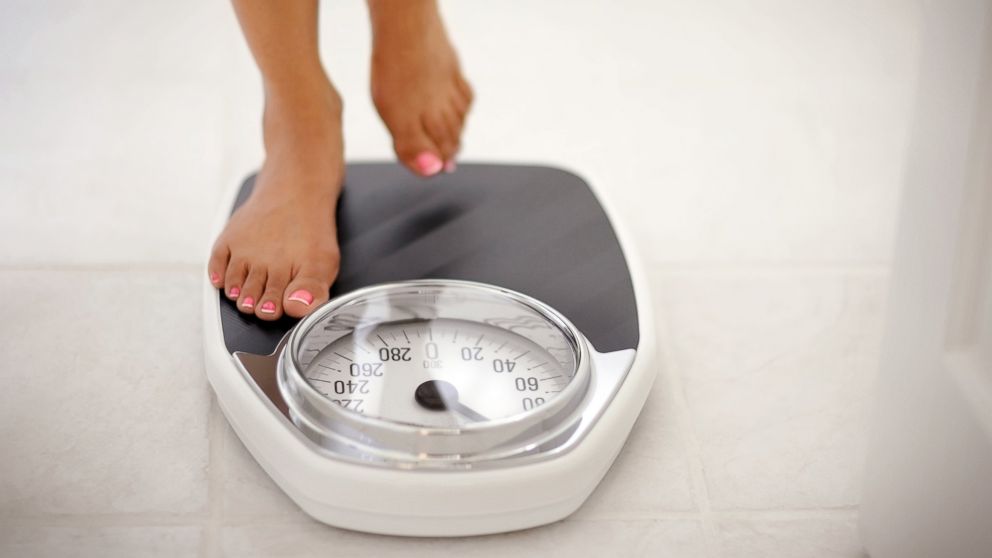 PHOTO: A woman stands on a bathroom scale in this undated stock photo.