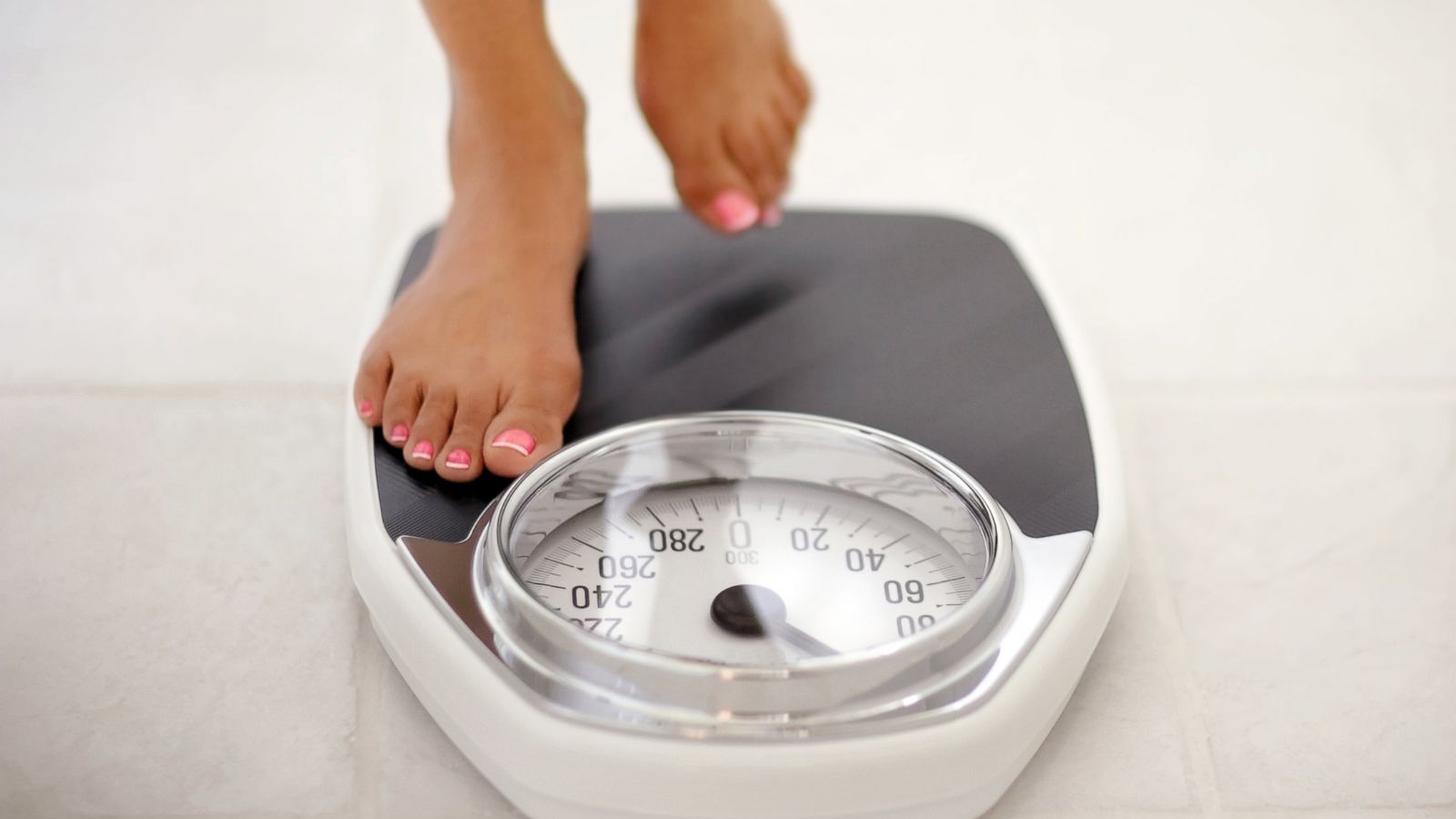 PHOTO: A woman stands on a bathroom scale in this undated stock photo.