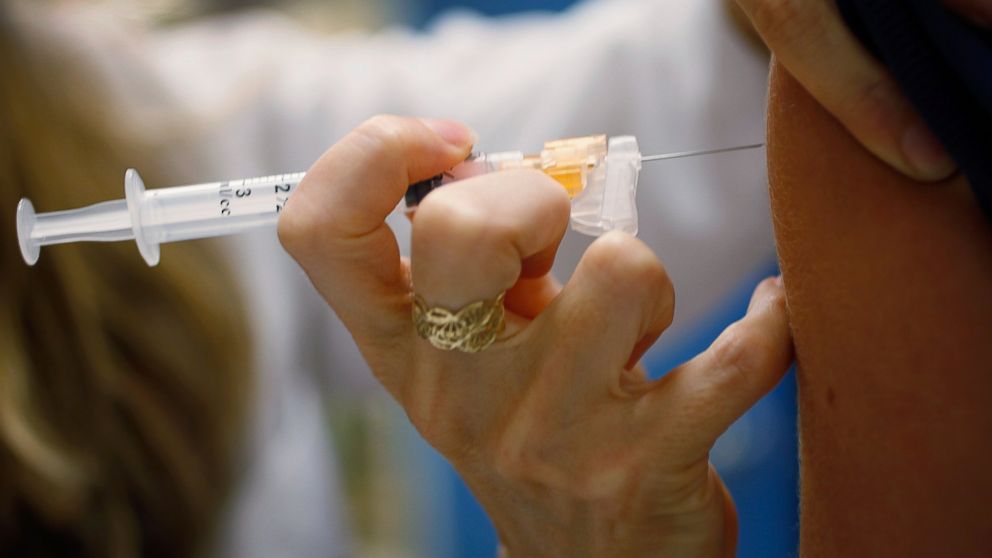 A pediatrician gives an HPV vaccination to a 13-year-old girl in her office, Sept. 21, 2011, in Miami, Florida. The vaccine for human papillomavirus, or HPV, is given to prevent a sexually transmitted infection that can cause cancer. 