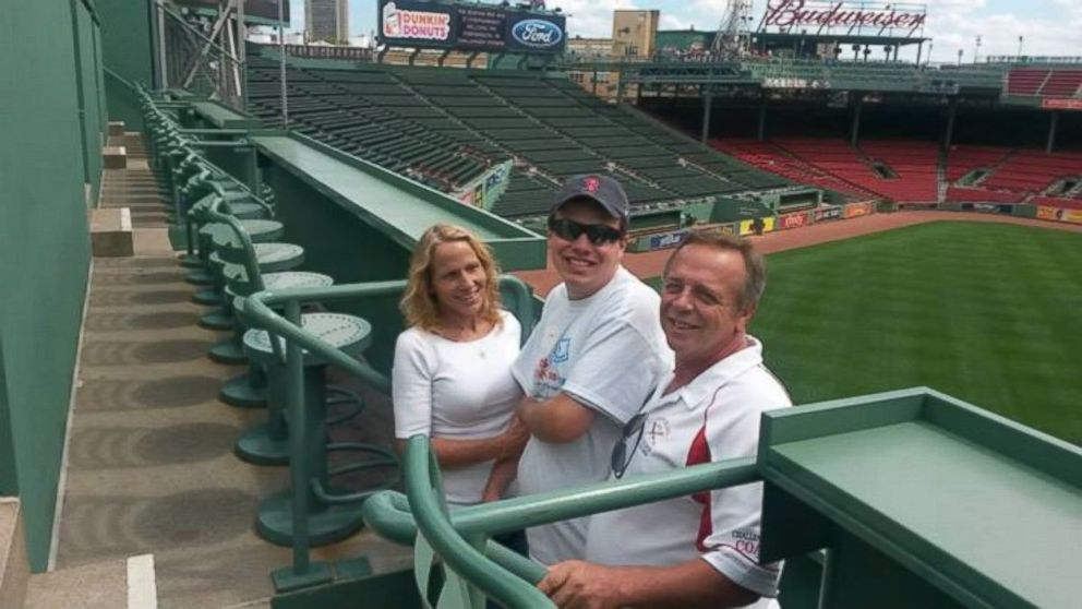 Applebee's apologized to Caleb Dyl after he was not paid since starting his position in the kitchen last year. Dyl is pictured in a baseball hat with his parents during a trip to Fenway Park last year. 