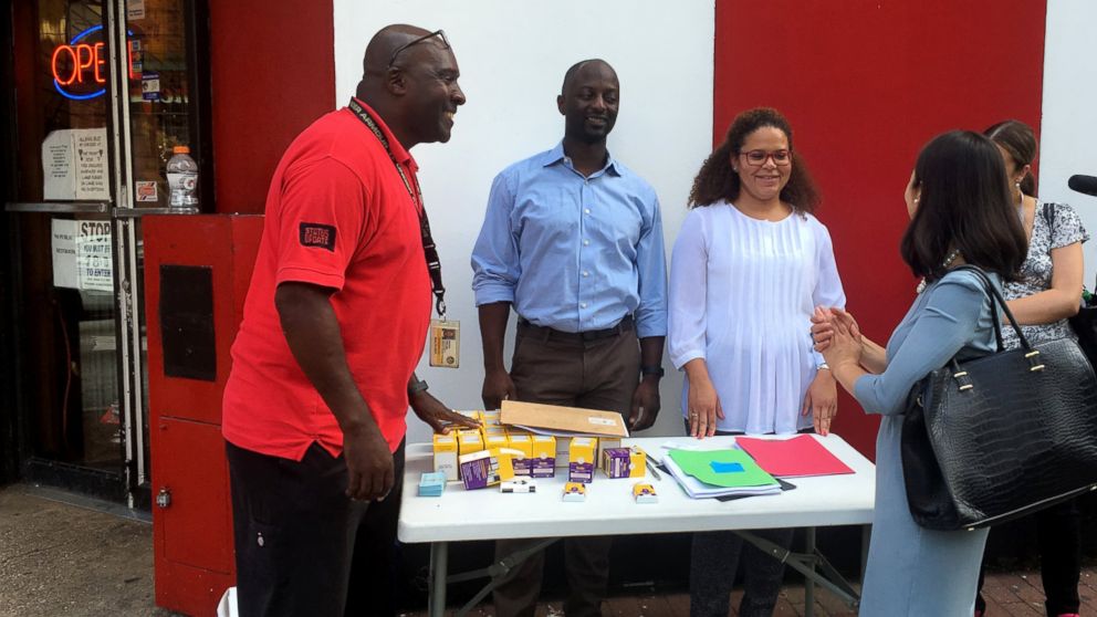 PHOTO:Nathan Fields, left,talks with Baltimore City Health Commissioner Dr. Leana Wen at a naloxone outreach station in Baltimore City providing education and dispensing the medication in observance of International Overdose Awareness Day.
