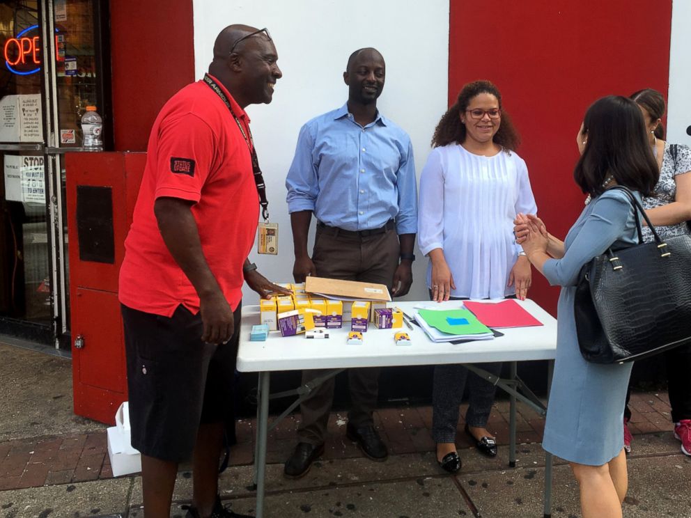 PHOTO:Nathan Fields, left,talks with Baltimore City Health Commissioner Dr. Leana Wen at a naloxone outreach station in Baltimore City providing education and dispensing the medication in observance of International Overdose Awareness Day.