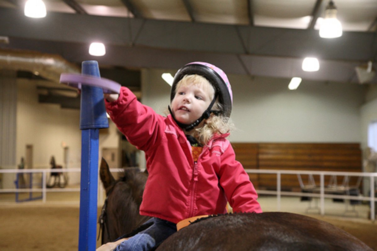 PHOTO: Brooke Kennedy rides a horse in physical therapy.