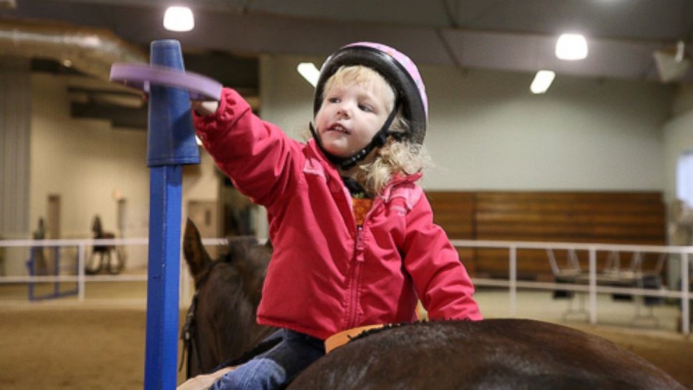 PHOTO: Brooke Kennedy rides a horse in physical therapy.