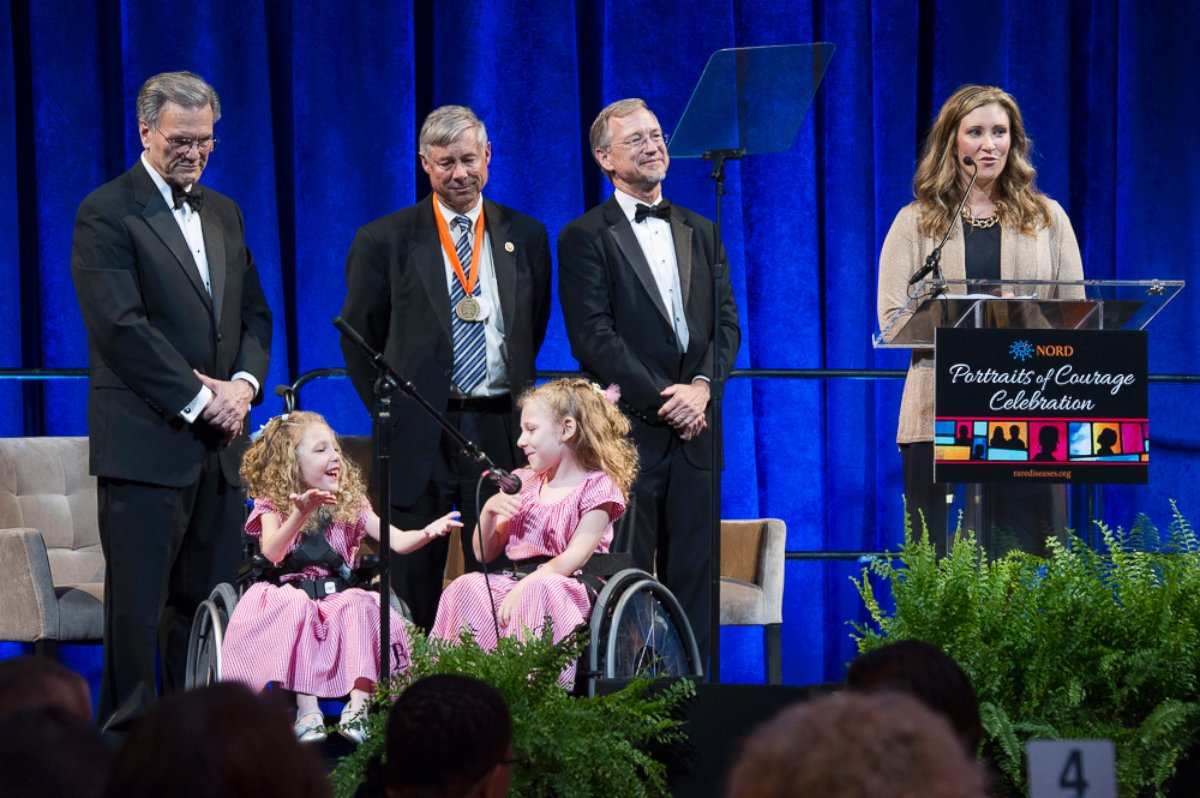 PHOTO: NORD President and CEO Peter L. Saltonstall, Rep. Upton, and NORD board member Frank Sasinowski stand with Brooke and Brielle Kennedy as Sarah Kennedy speaks.