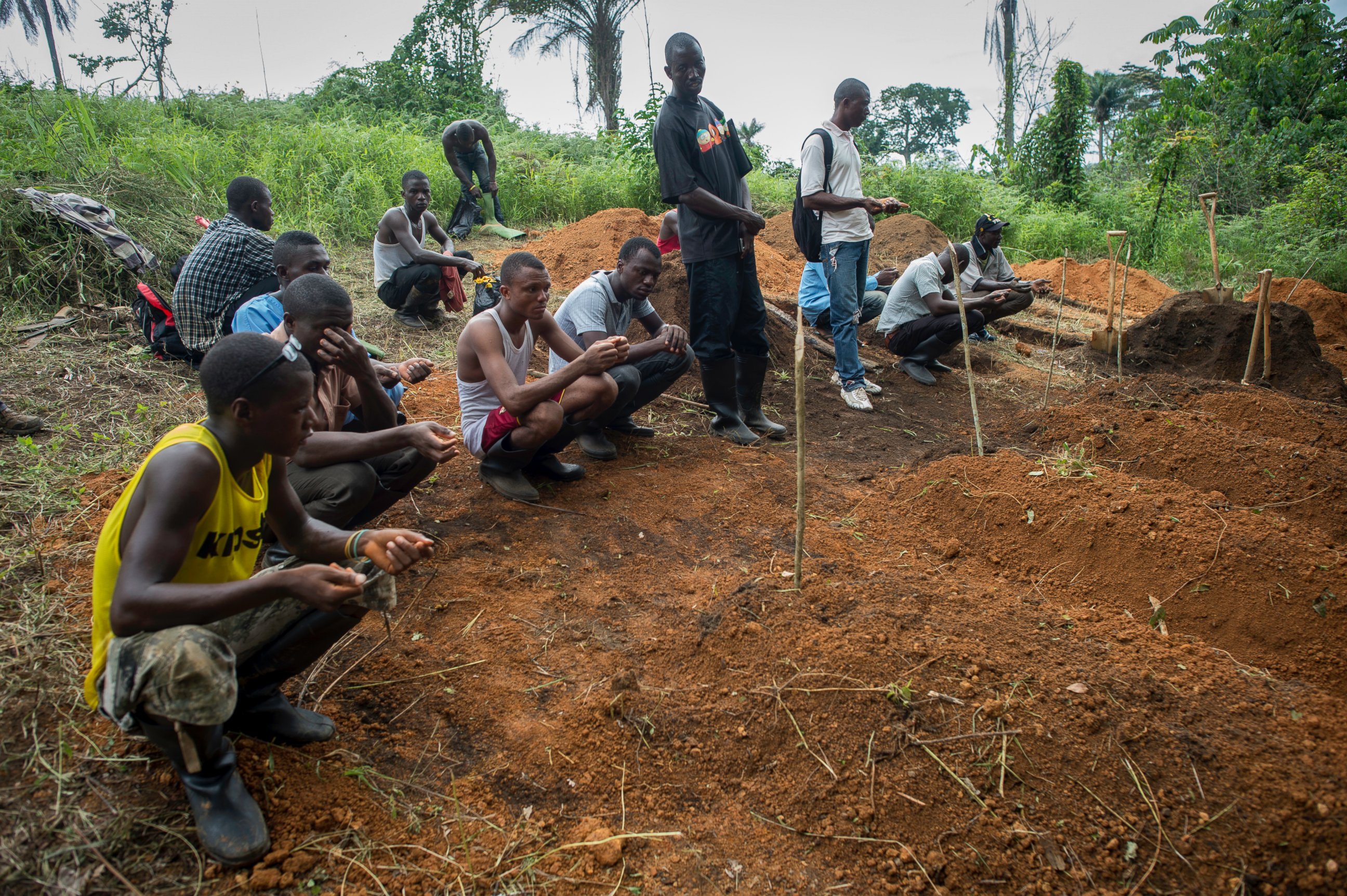 PHOTO: A World Health Organization (WHO) team is burying the deceased patients whose families did not come in the forest near the MSF Treatment Centre in Kailahun, Sierra Leone.