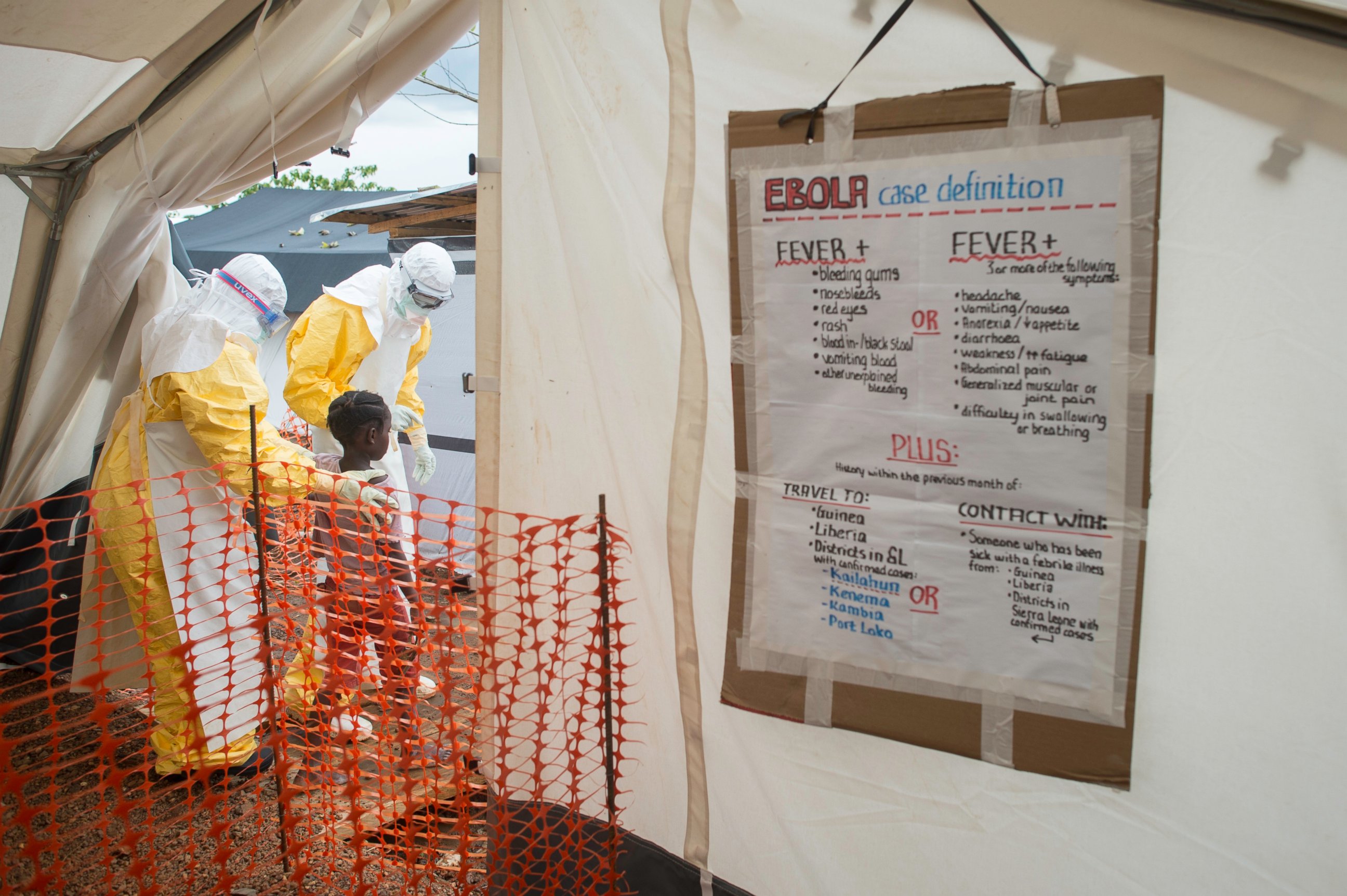 PHOTO: MSF staff show the way inside the Treatment Centre to a patient most likely infected with the Ebola virus/