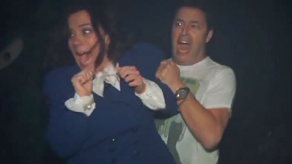 Amy Rhodes and Andy Lassner navigate a haunted house at Universal Studios' Horror Nights.