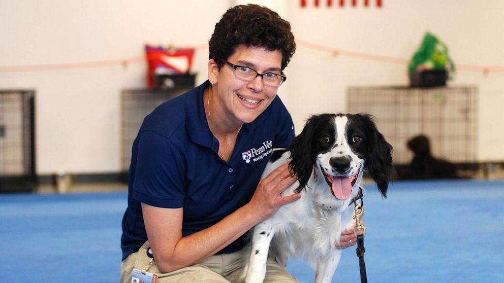 Penn Vet Working Dog Center's Cynthia M. Otto poses for a photo with sniffer dog McBaine Chamberlain.