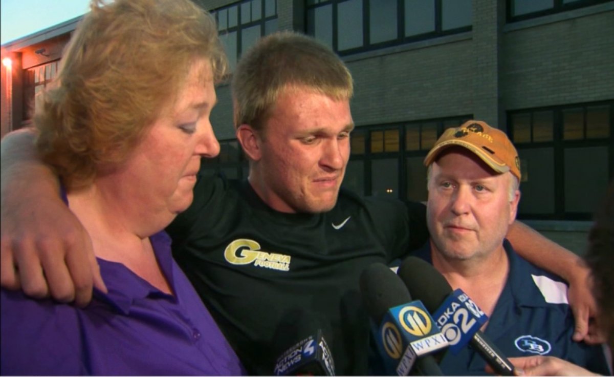 PHOTO: Noah Cornuet's parents and his older brother, Shane, mourn at a vigil.
