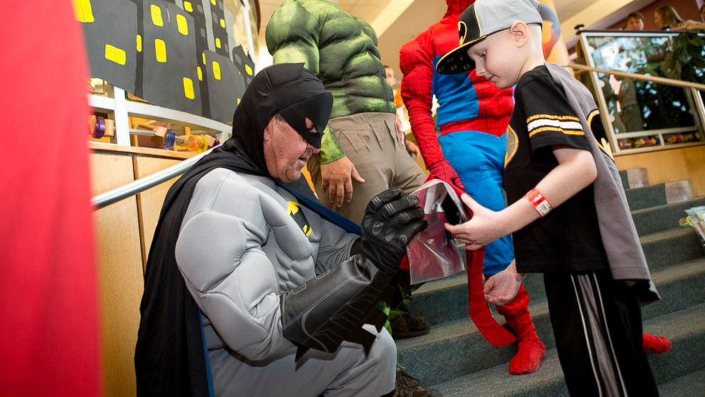 PHOTO: Roger Corcoran, a 61-year-old grandfather, signs autographs as Batman for a fan.