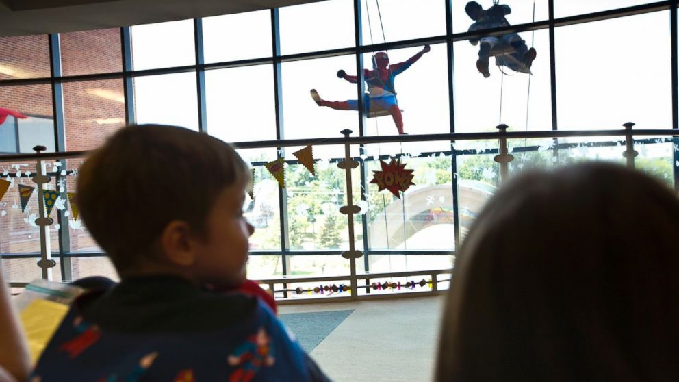 PHOTO: The staff, children and parents gathered in an auditorium to watch the superheroes rappel
