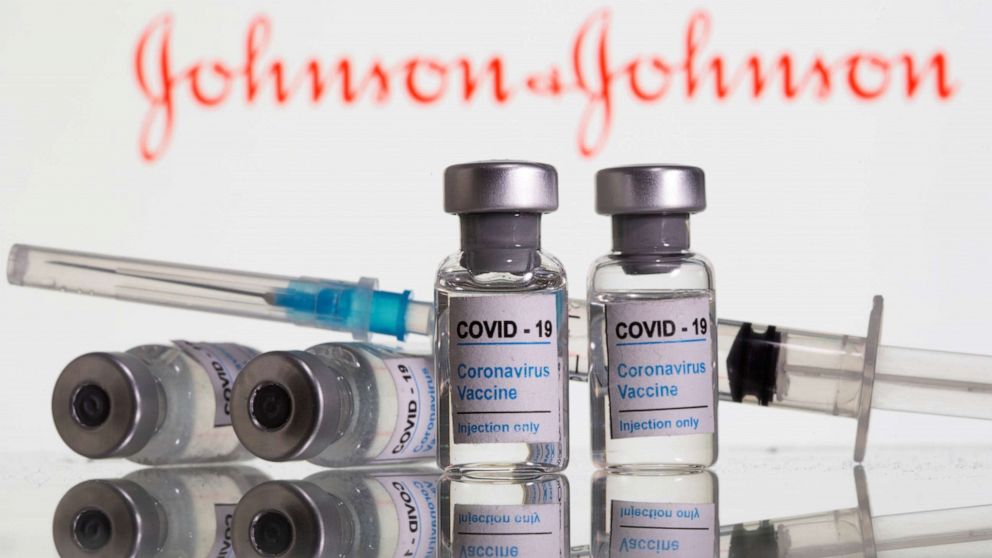 FILE PHOTO: Vials labelled "COVID-19 Coronavirus Vaccine" and syringe are seen in front of displayed Johnson & Johnson logo in this illustration taken, February 9, 2021. 